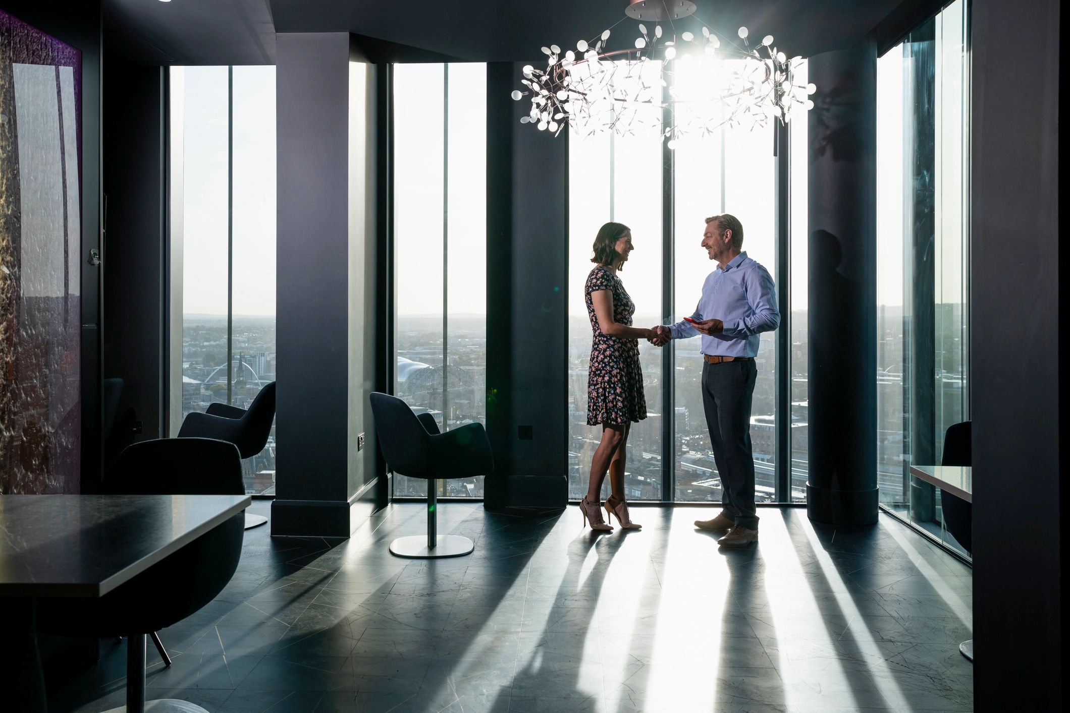 Consultant and client shaking hands in a modern office