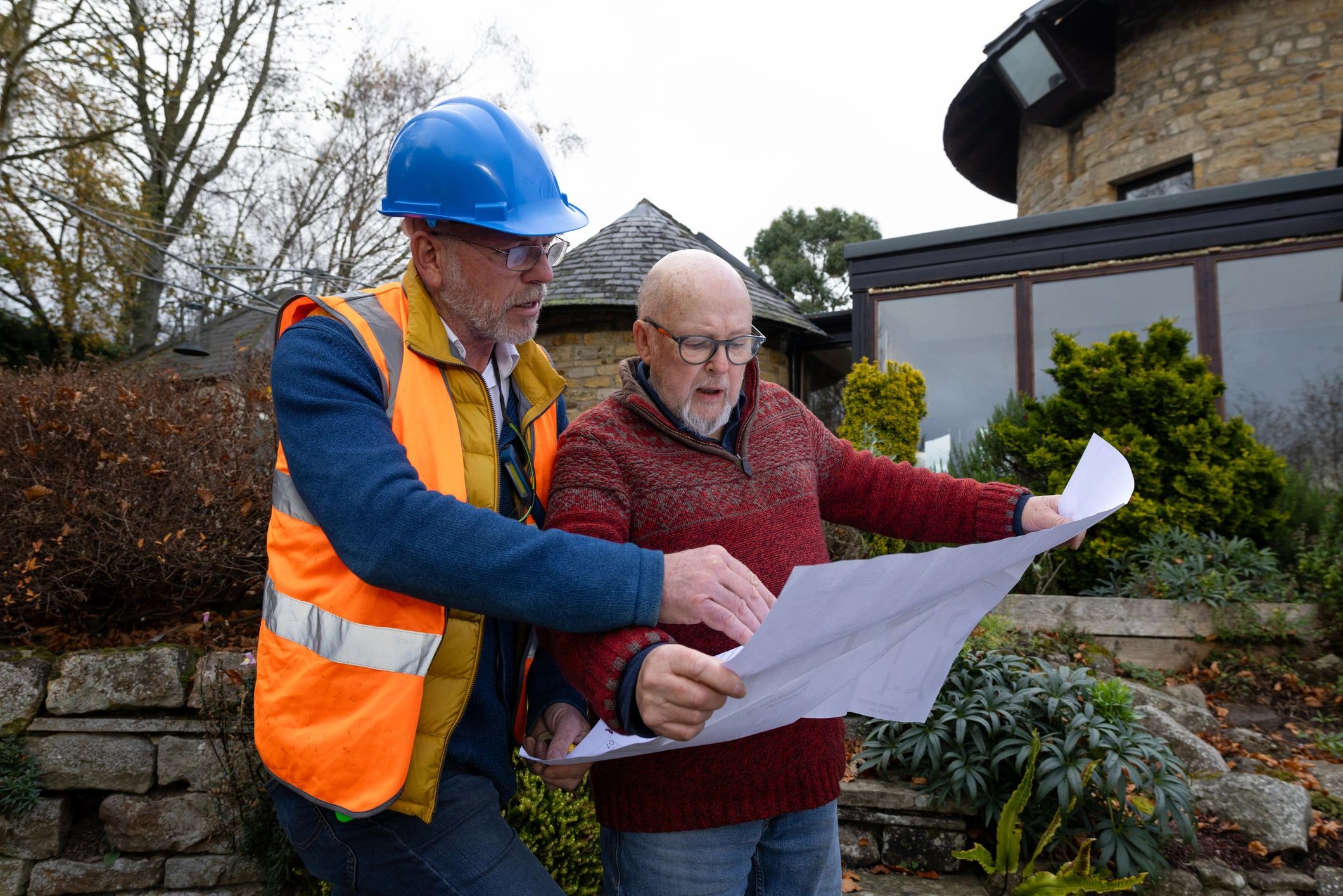 Professional reviewing construction plans with a client